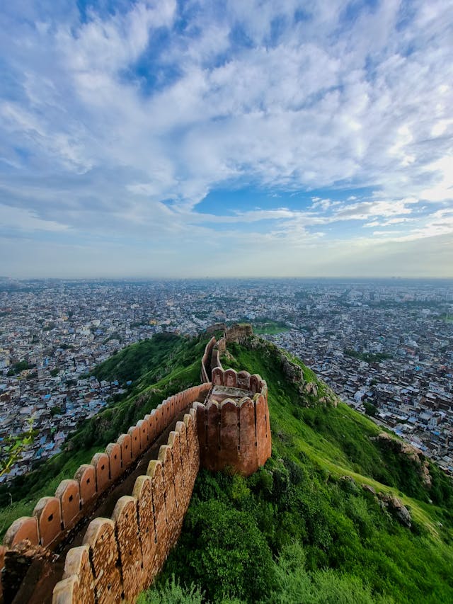 Panoramic view of Nahargarh Fort wall on a green hill overlooking the city of Jaipur, India.