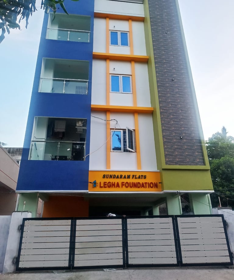 Sundaram Flats by Legha Foundation, a modern multi-story residential apartment building with a colorful facade.
