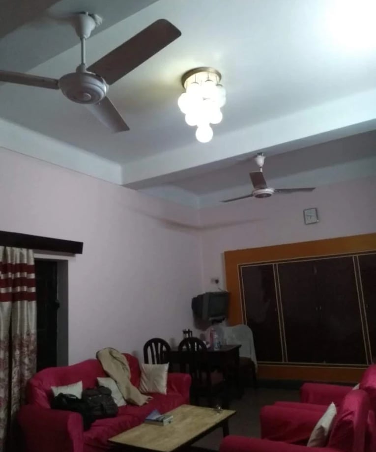 a living room with a ceiling fan and a ceiling fan