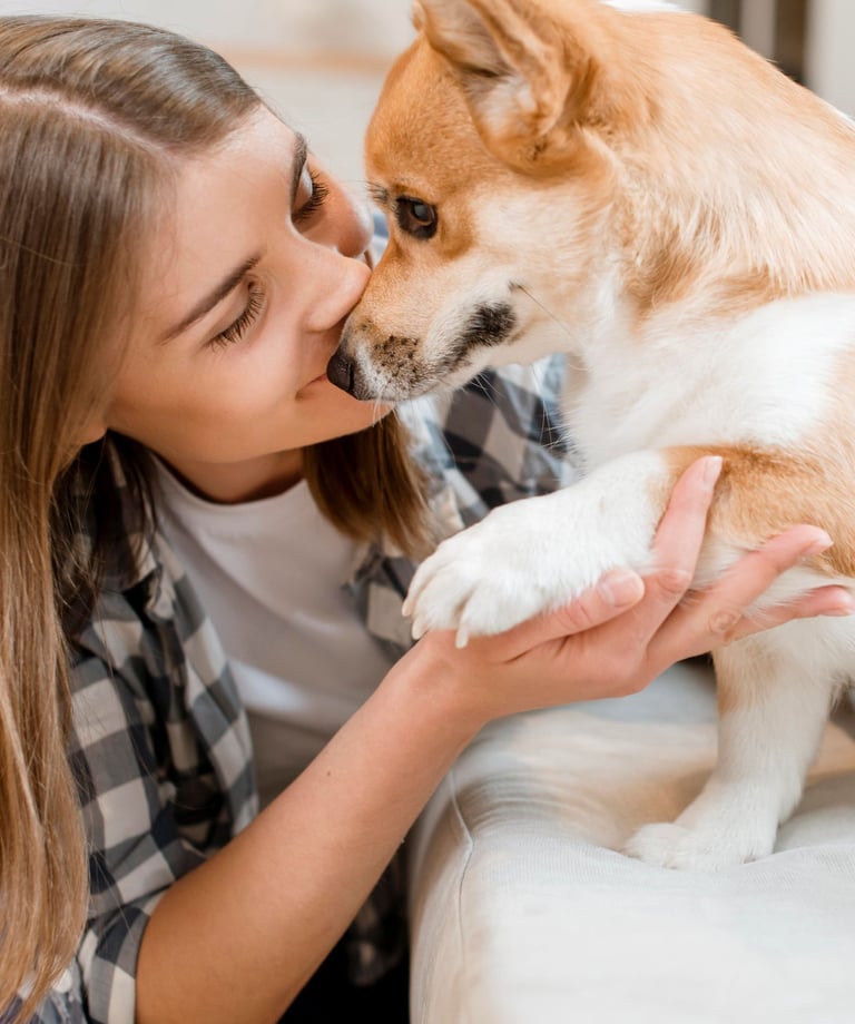 a woman is kissing a dog