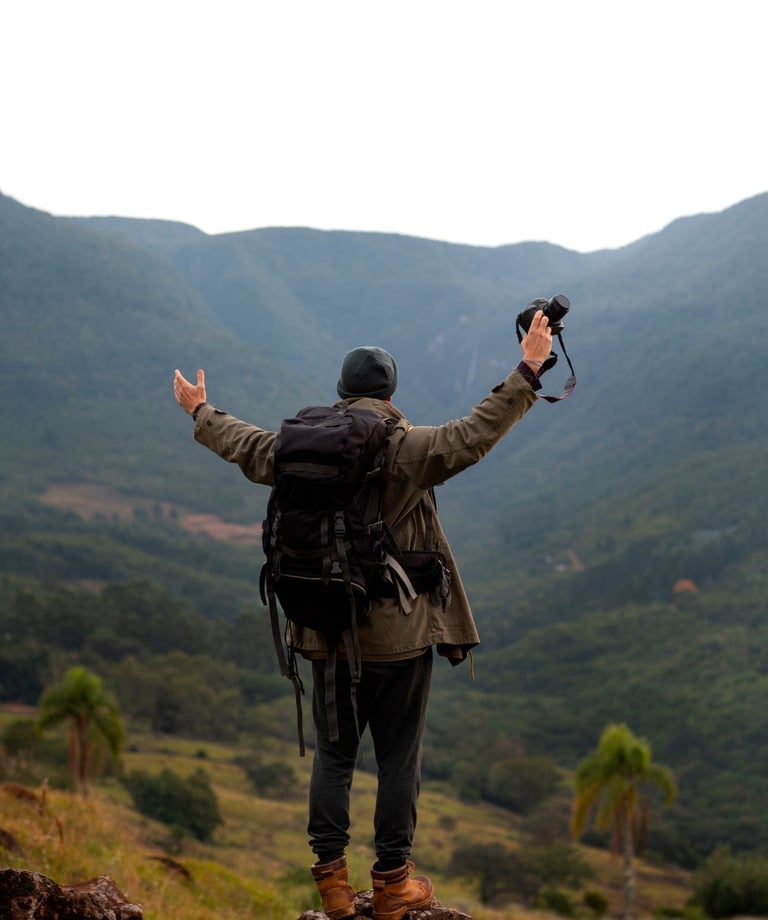 a person standing on a rock with a backpack