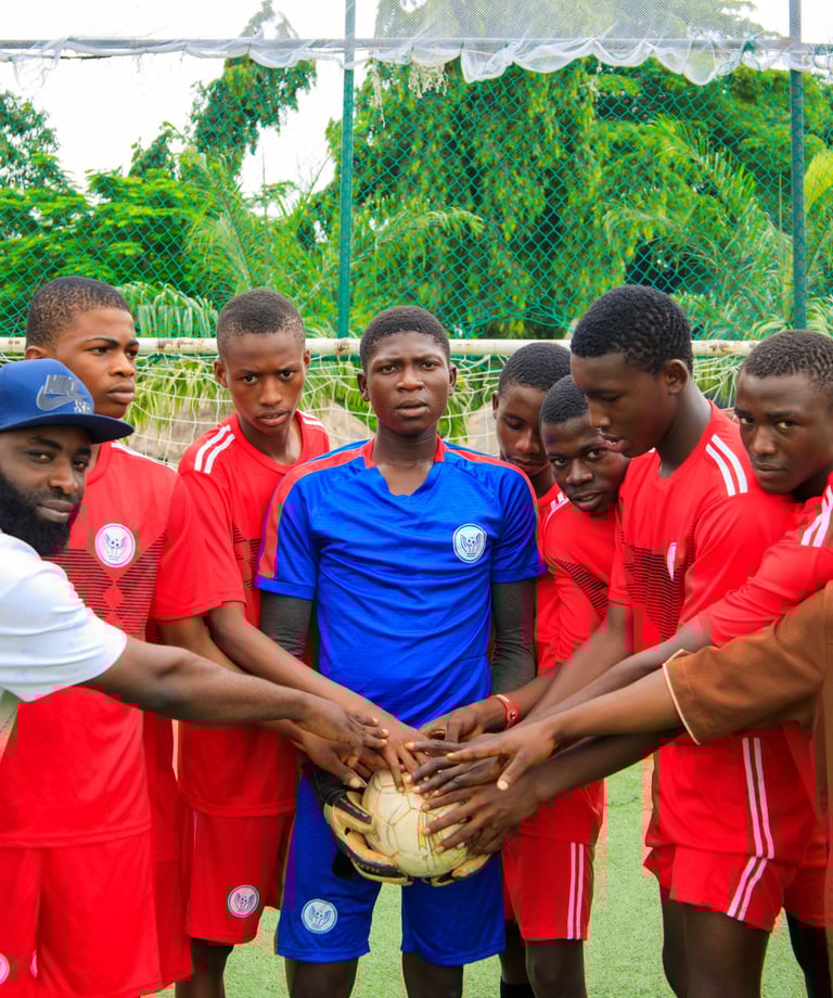 a group of men standing around a soccer ball