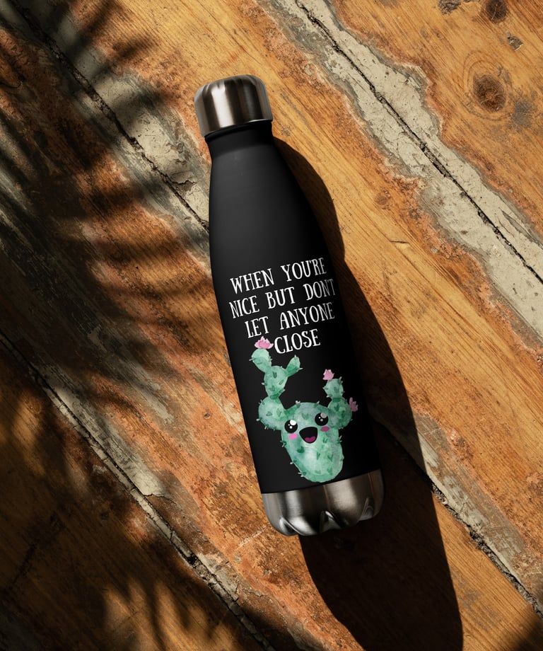 Black cactus-themed stainless steel water bottle on rustic wooden surface.