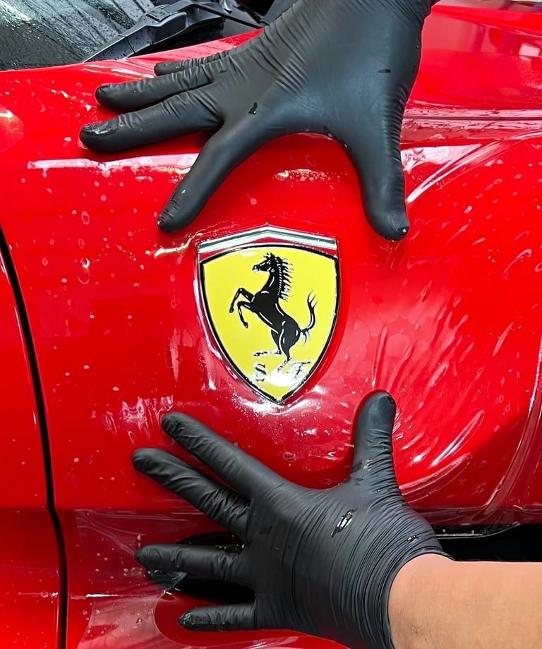 Installation d'un PPF sur le bloc avant d'une Ferrari dans notre atelier en Isère
