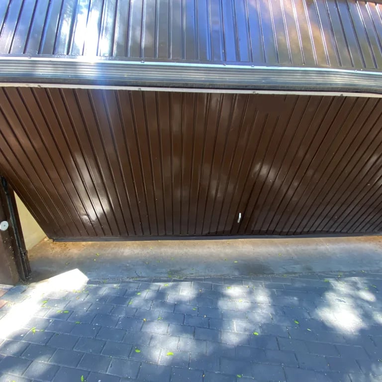 a parking garage door with a large wooden door