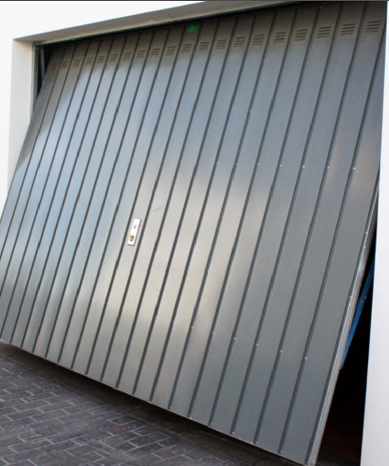 a garage door with a large metal door and a large garage door