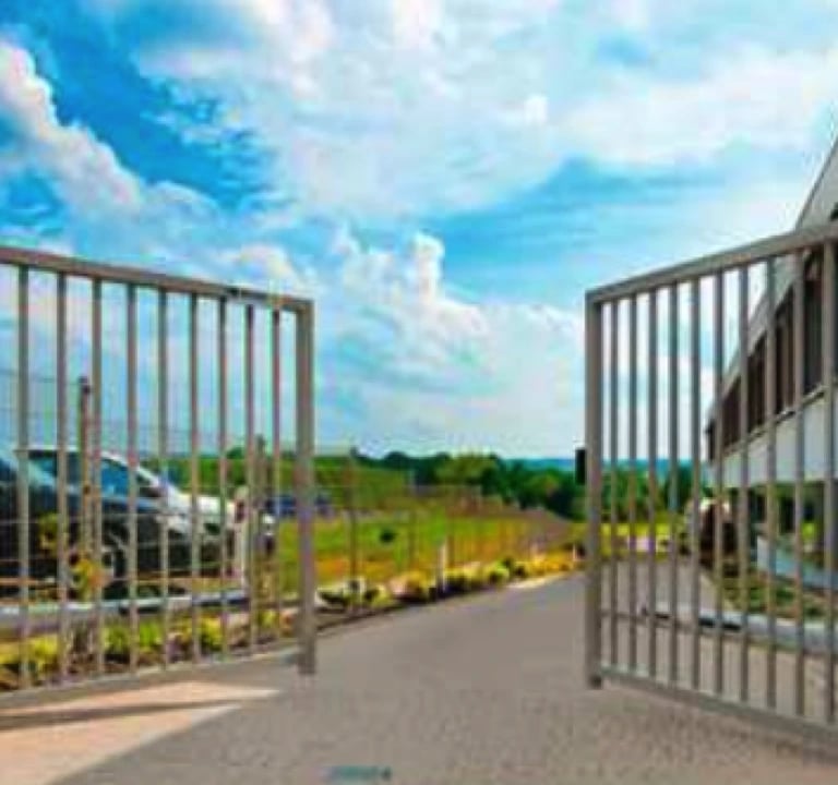 a gated in area with a fenced in area with a fenced in