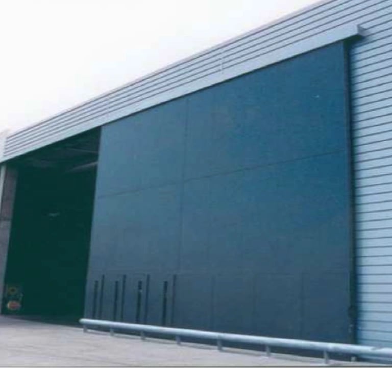 a large industrial warehouse with a large blue door