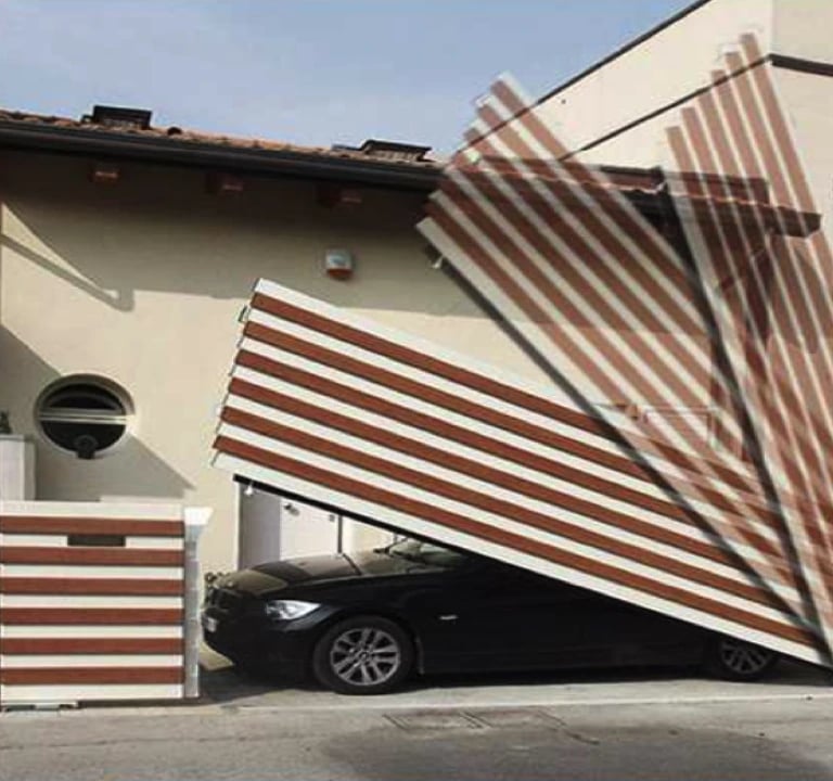 a car parked in front of a house with a large wooden fence