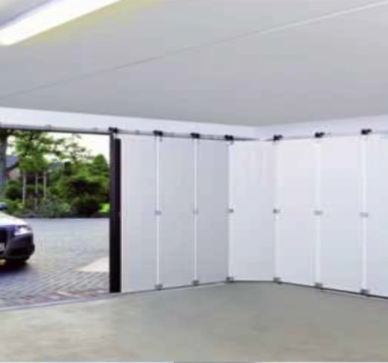 a car parked in a garage with a car in the background