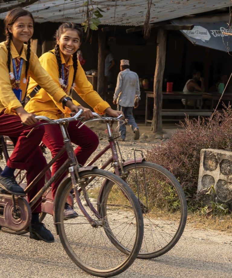 schoolgirls on bicycles in bardiya