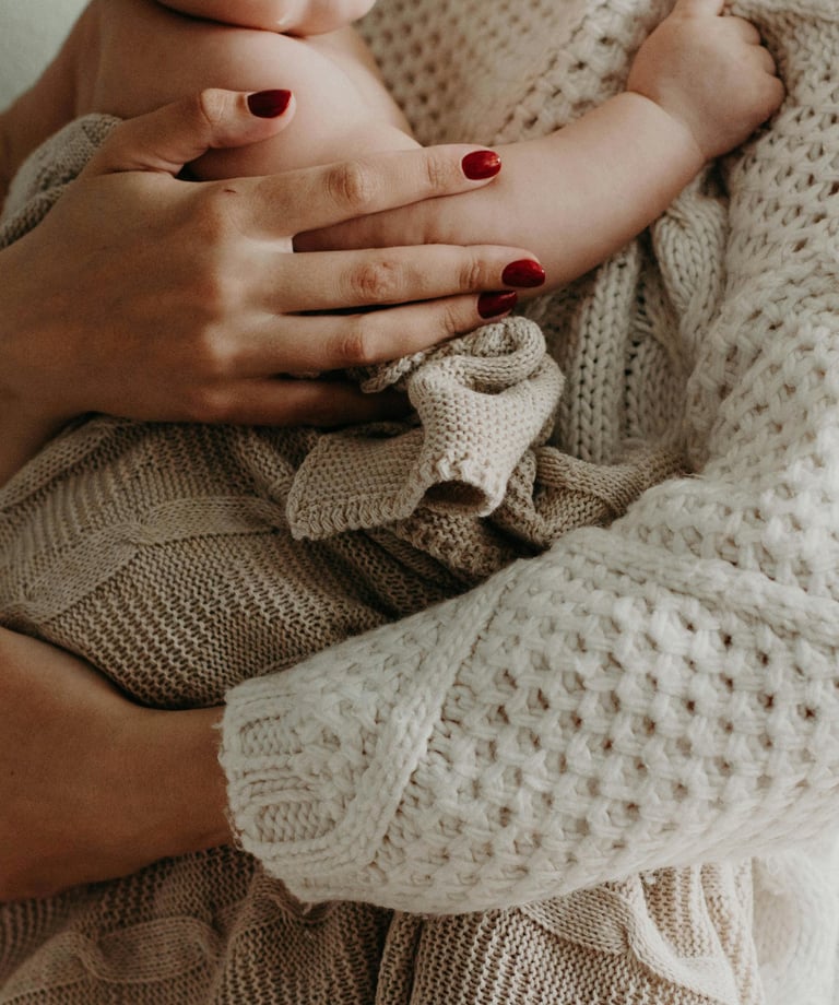 a woman holding a baby in her arms