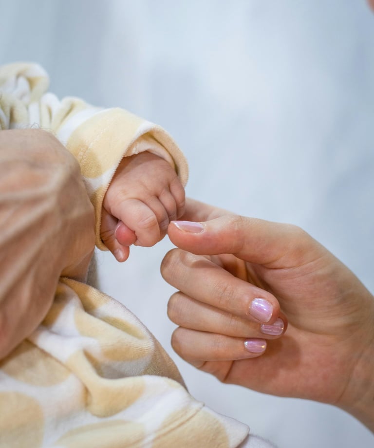 a baby's hand holding a baby's finger