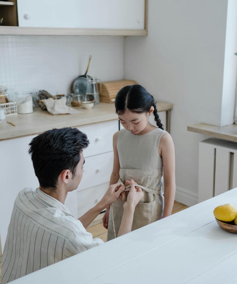 a man and woman standing in a kitchen