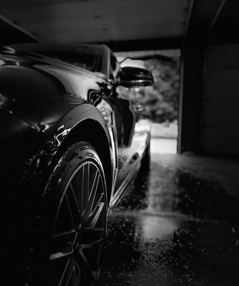 Sparkling black sedan after a premium wash and rinse.