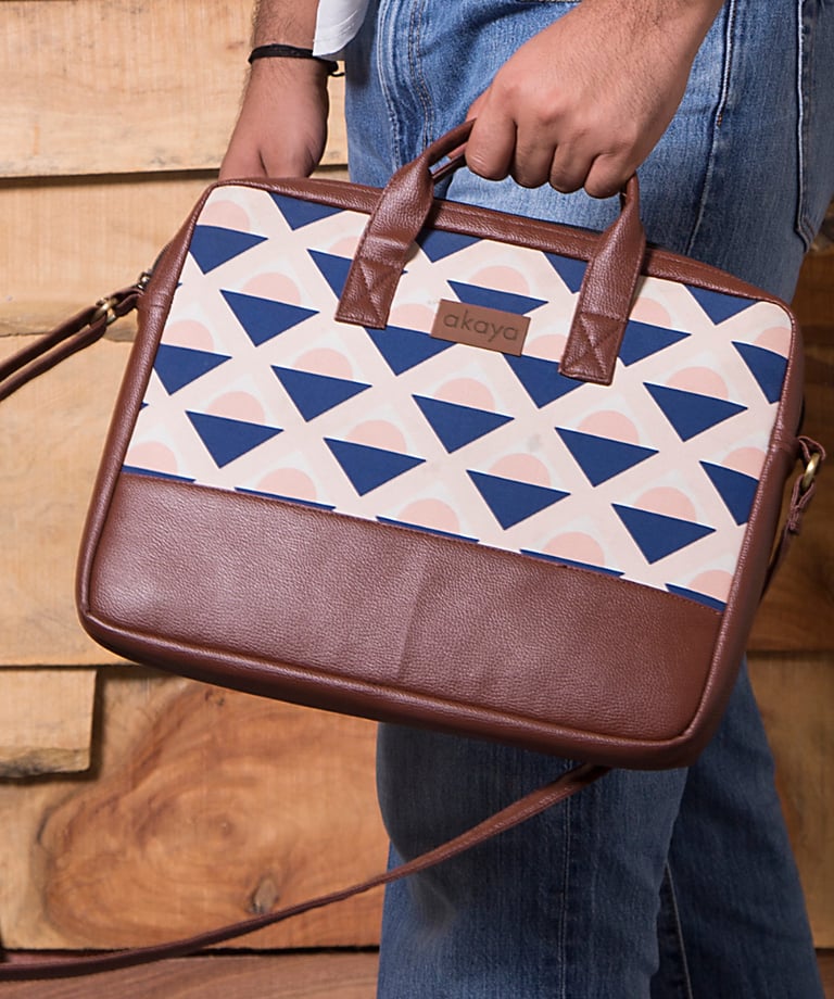 a man holding Akaya India's handmade messenger bag