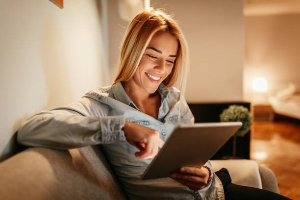 a woman sitting on a couch with a laptop
