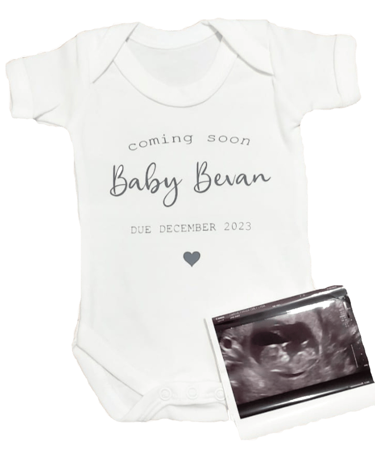 a baby's bodysuit with a baby's birth announcement