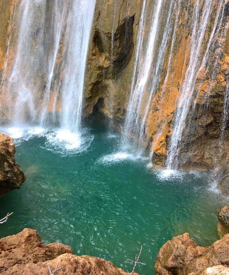 a waterfall in a canyon near a waterfall