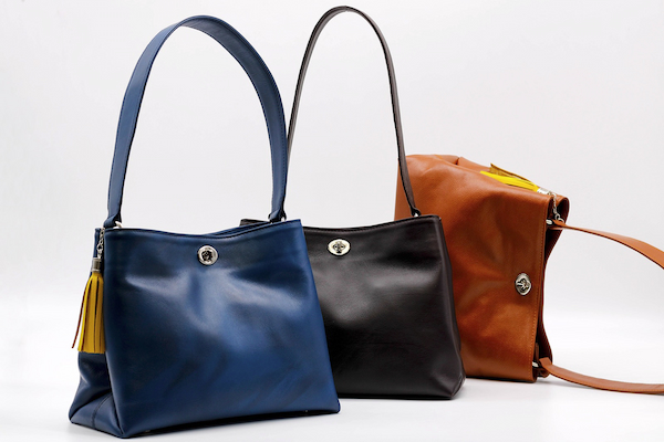 a pair of two handbags with a leather bag