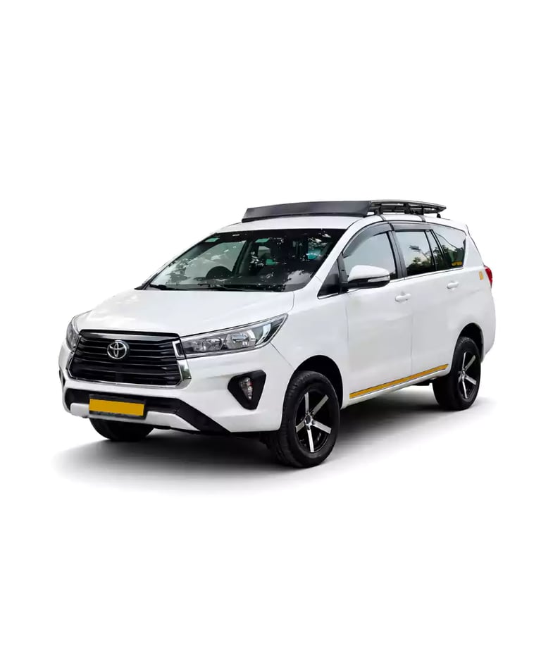 White Toyota Innova Crysta one way taxi by Saini taxi services with a luggage carrier rack