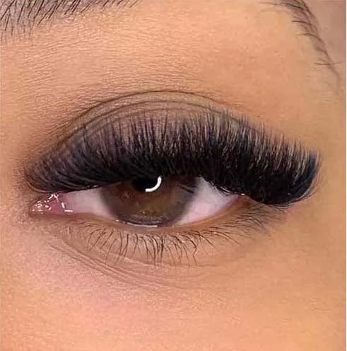 a woman's mega volume eyelash extensions and lasheshadow on her eyeliners