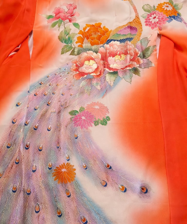 Vintage Japanese orange silk kimono featuring an embroidered peacock with floral peony motifs.