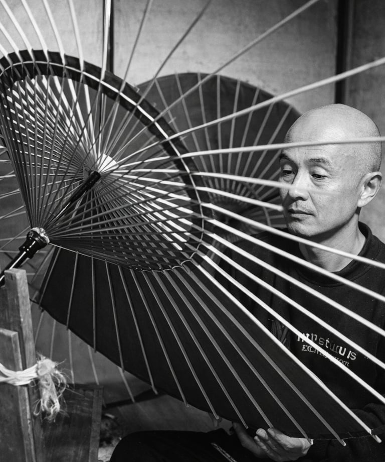 A Japanese artisan meticulously crafts a traditional wagasa oil-paper umbrella with bamboo ribs.