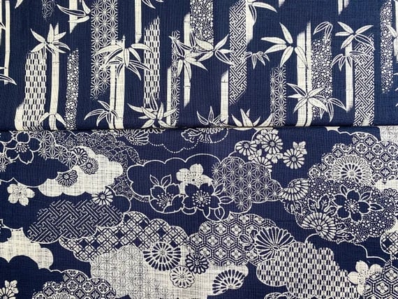 Japanese indigo blue fabric with traditional white bamboo leaves and floral cherry blossom patterns.