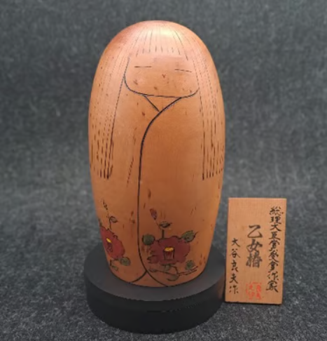 Vintage Japanese Sosaku Kokeshi wooden doll with hand-painted red camellia flowers.