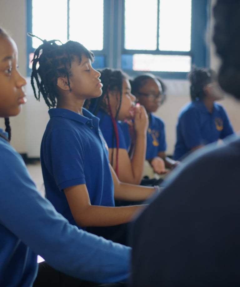 Students practicing deep breathing.