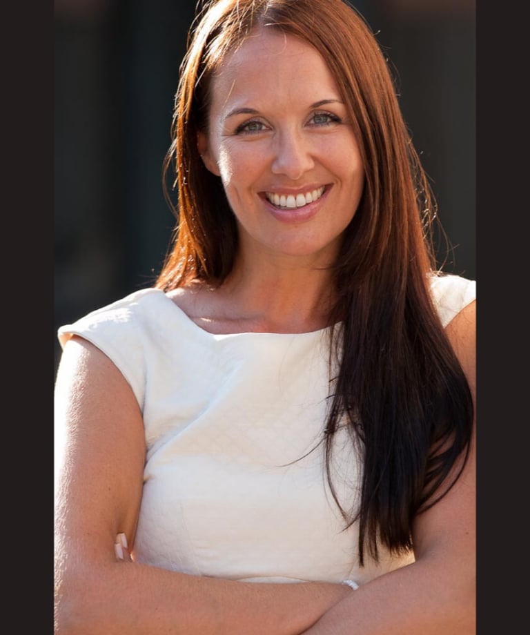 a woman with long hair and a white top