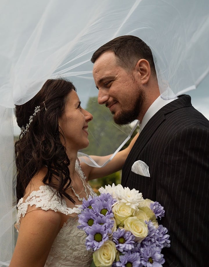 Bride and groom sharing a romantic moment during a wedding photoshoot in Preston Park, Brighton.