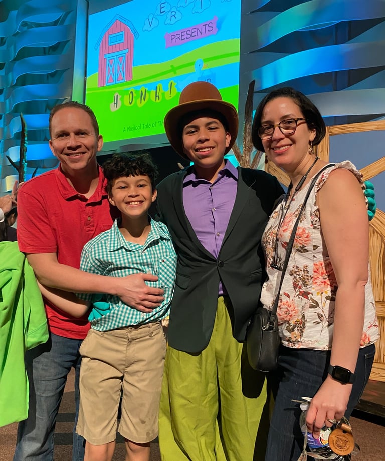 a family posing for a picture in front of a screen