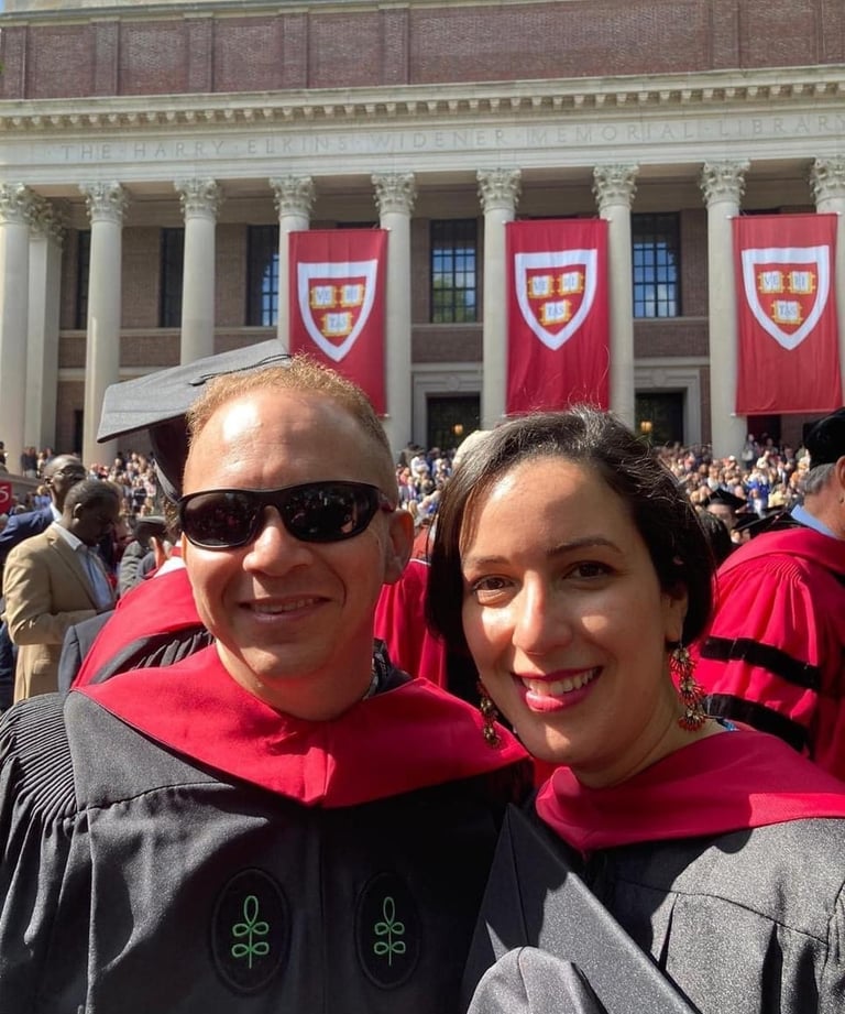a man and woman in graduation gowns and caps