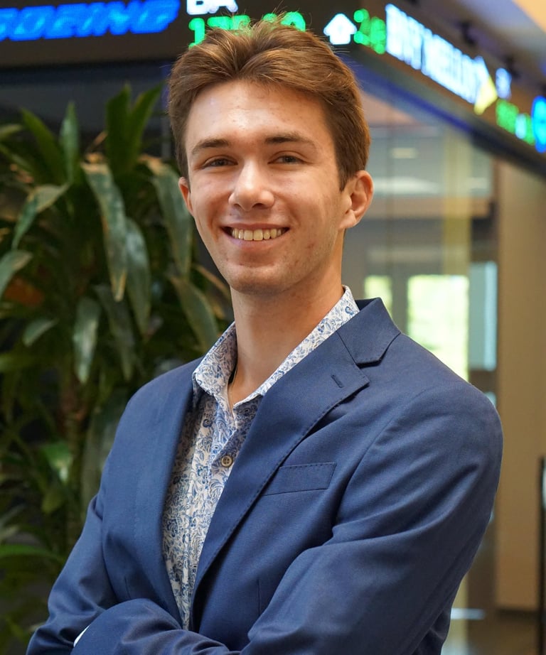 A headshot of Luke Gilmore in a suit.