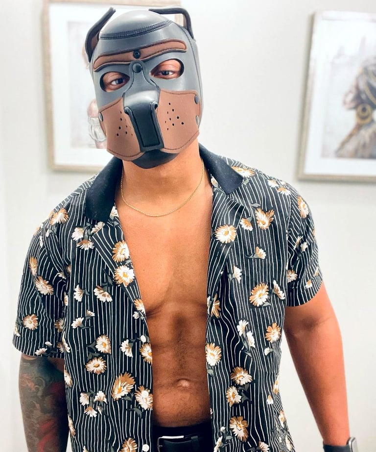 Man poses in a pup hood.