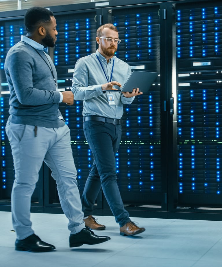 Two people walking in data center dressed in work attire