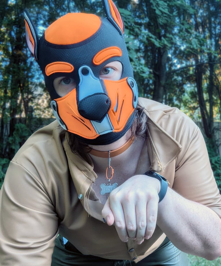 A man in a pup mask outdoors.