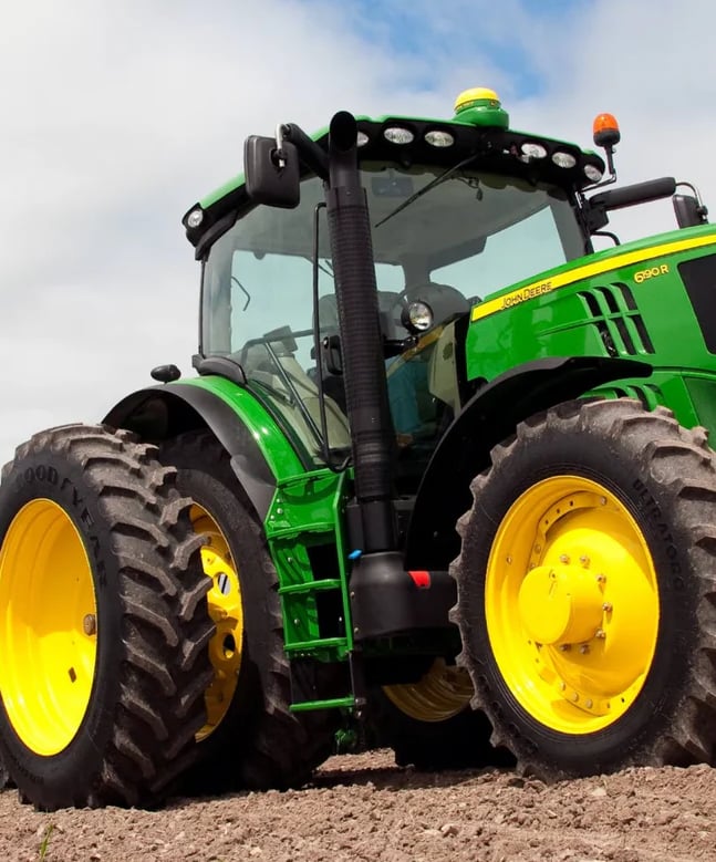 a tractor with a tractor in the middle of a field