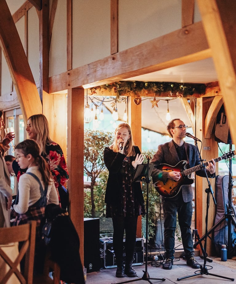 singer and guitarist in wedding barn for reception