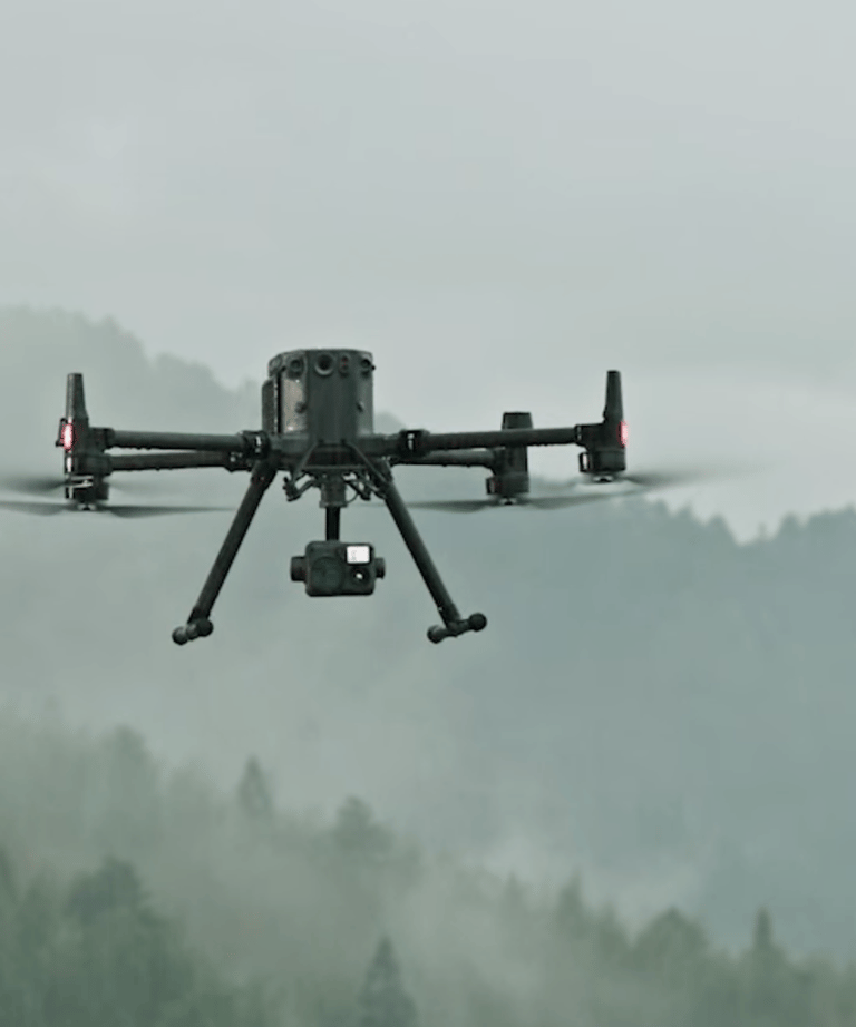 a small drone flying over a mountain range