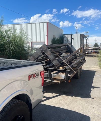 a truck with a trailer trailer loaded with a load of wood