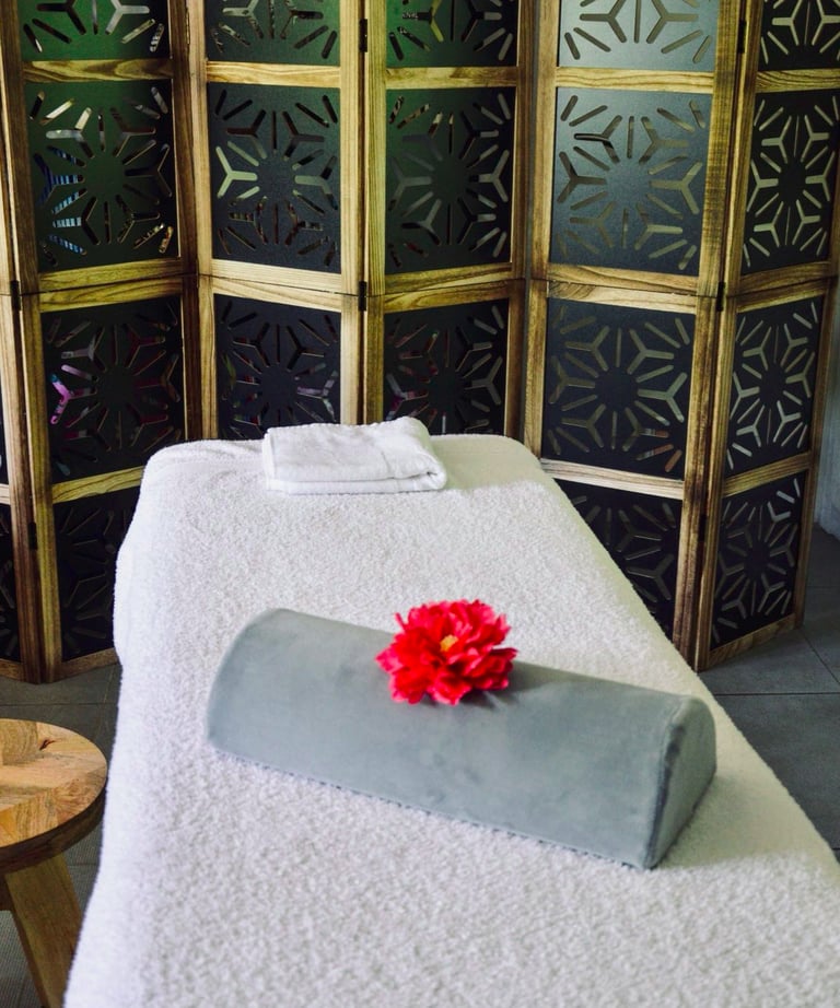 a massage room with a flower on the table