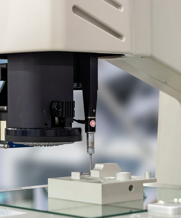 Micro-Vu optical CMM performing a CMM touch probe on a machined part.