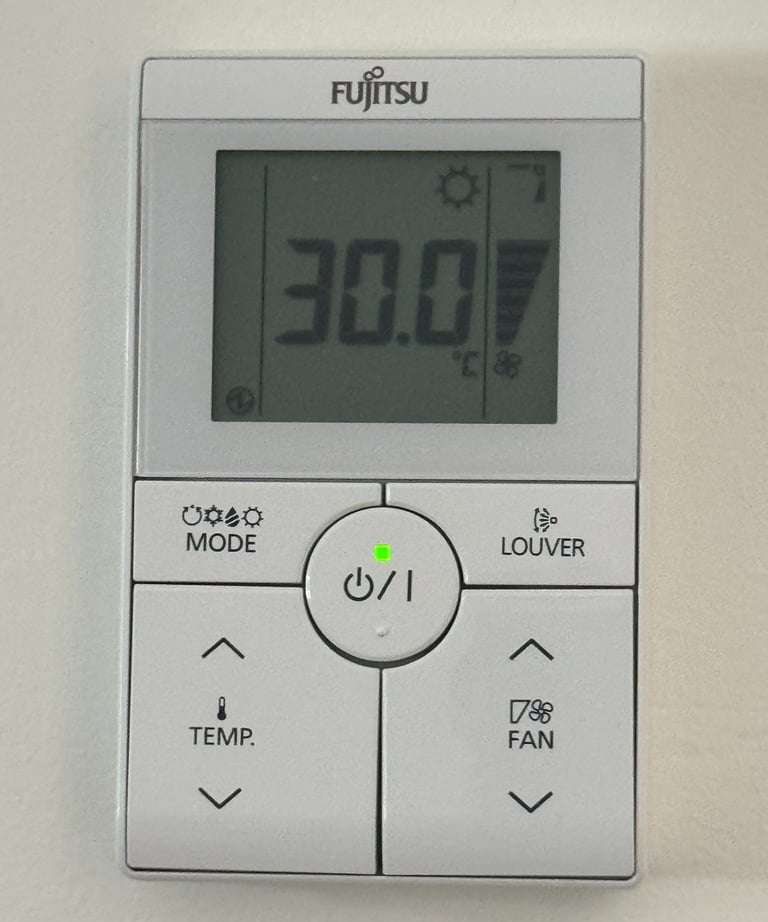 a digital clock on a wall mounted on a wall