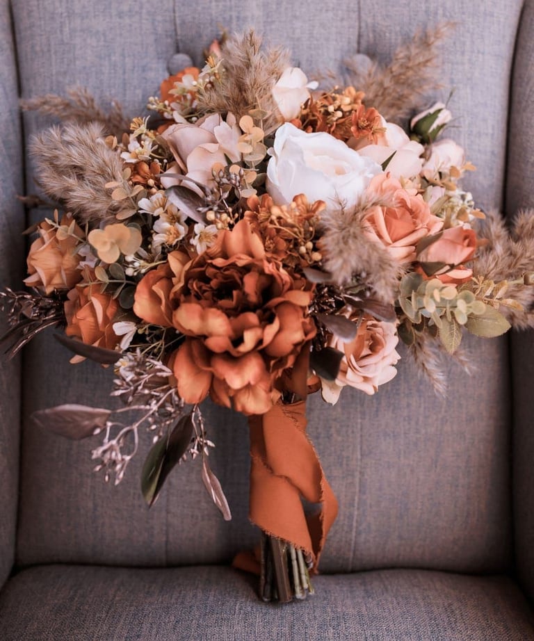 a bouquet of autumn flowers on a chair