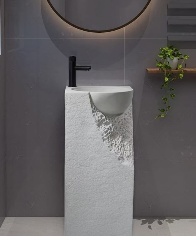 a bathroom with a sink and a plant in the background