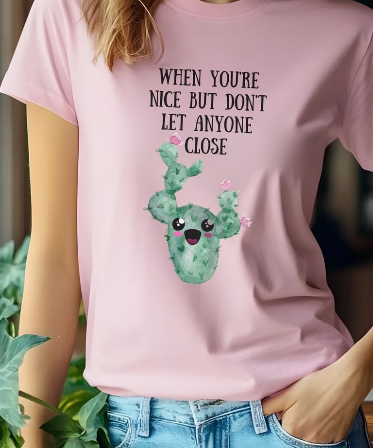 Woman wearing a pink graphic plant t-shirt with a cute smiling cactus design from Miss Chatty Plants.