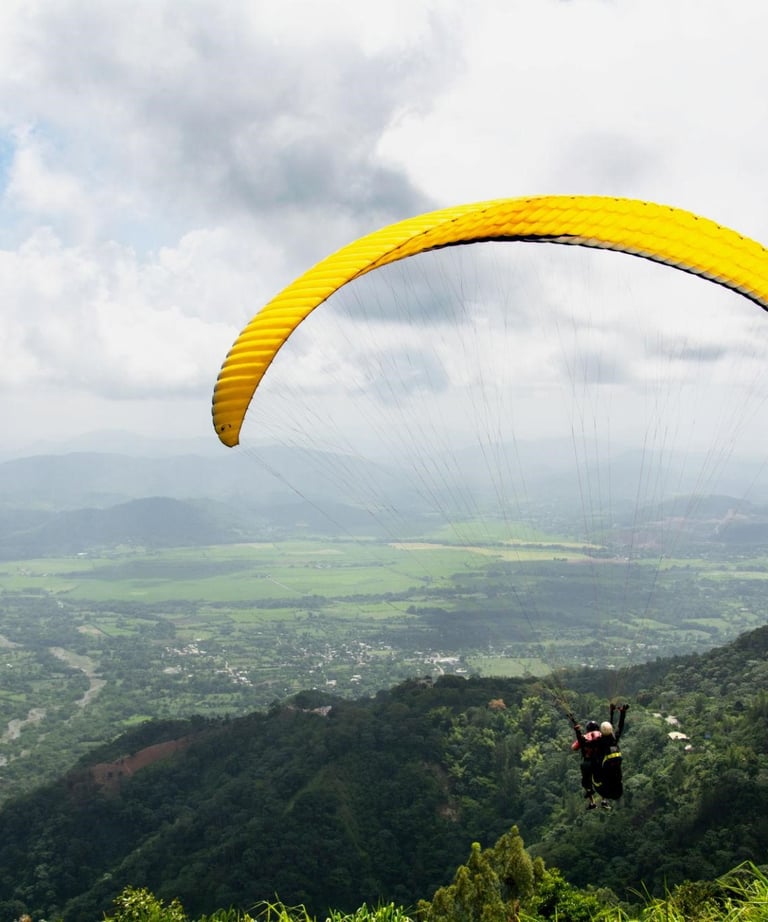 Paragliding over Jarabacoa Dominican Republic with panoramic mountain views and green valleys